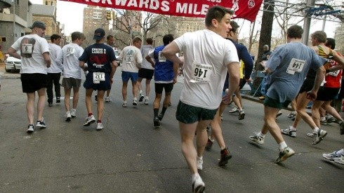 Hombres corren hacia atrás durante la carrera Backwards Mile en 2002.
