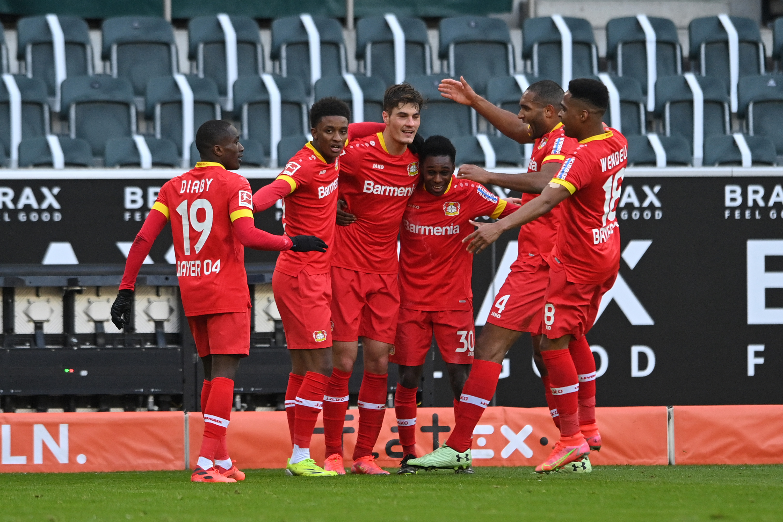  Bayer Leverkusen players celebrate a goal during a Bundesliga match.